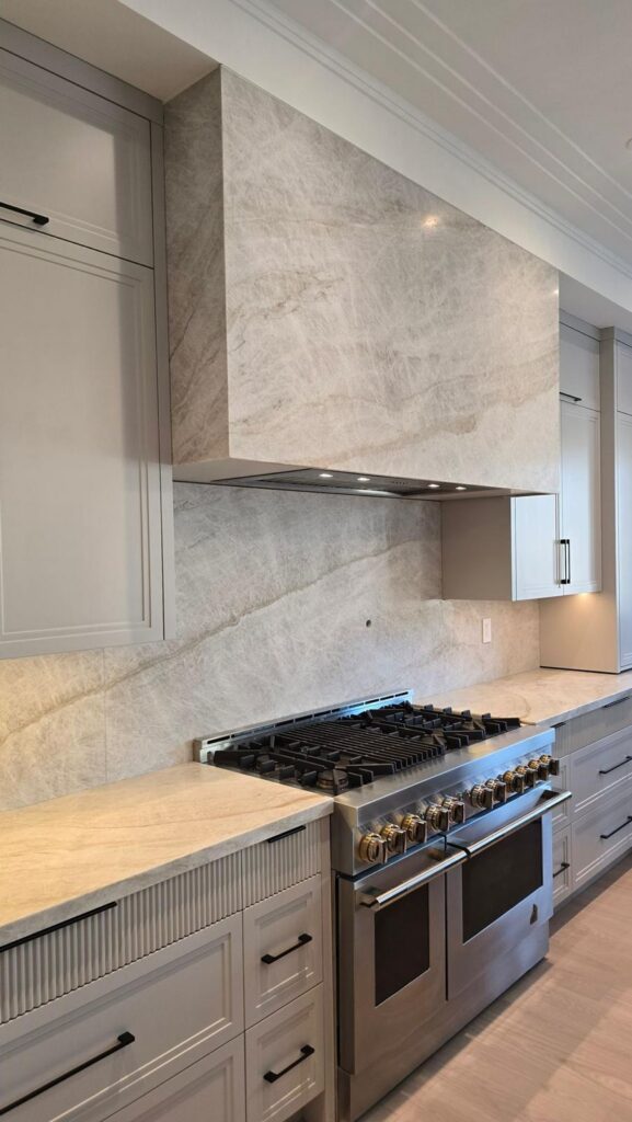 Custom Taj Mahal Quartzite wall fabrication and installation for residential Kitchen.