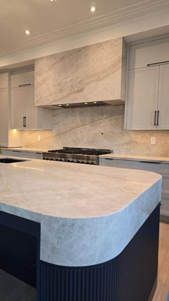 Modern residential kitchen renovation featuring premium Taj Mahal Quartzite in Oakville.